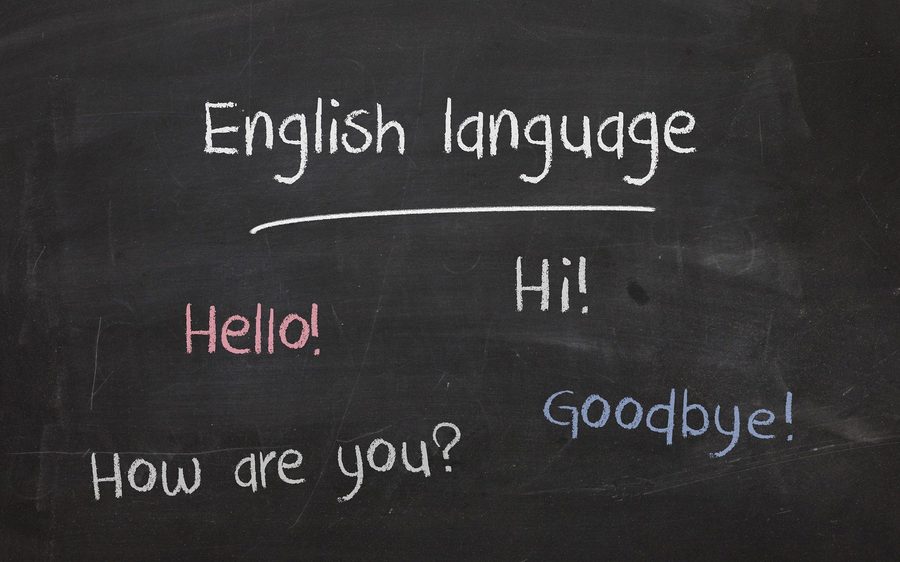 Pizarra con saludos en inglés escritos con tiza de colores